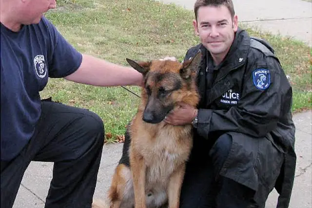 Officers Benjamin Reiver and Edward Carr with Charlie the German Shepard